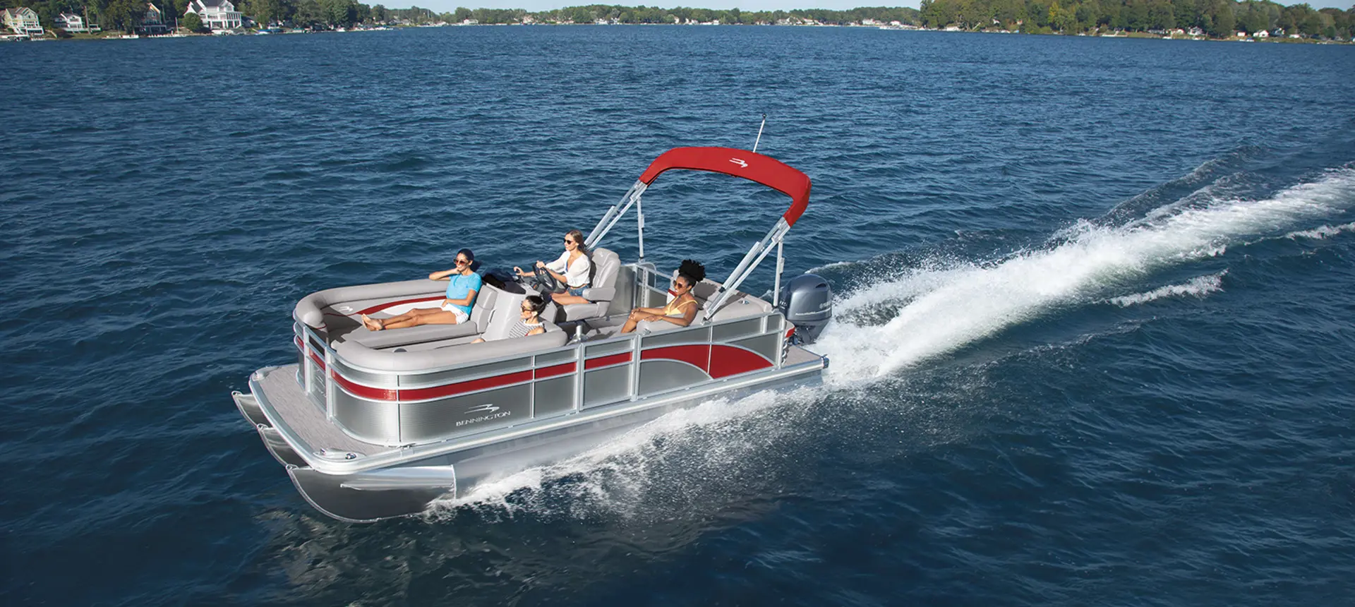 4 women on a bennington s pontoon boat crusiing a lake