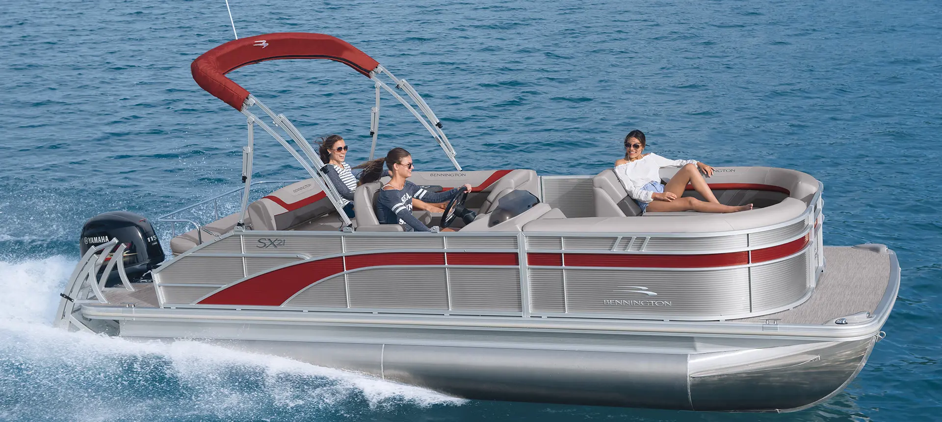 Bennington SX pontoon boat speeding across a lake