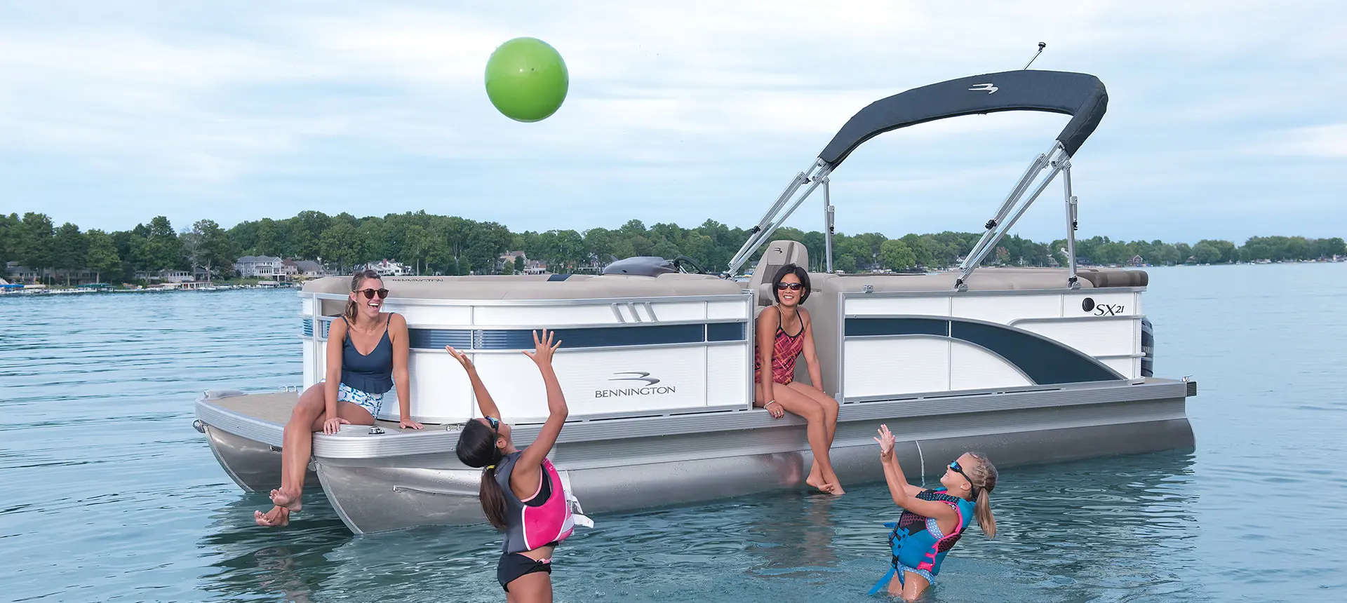 kids playing near a Bennington SX pontoon boat