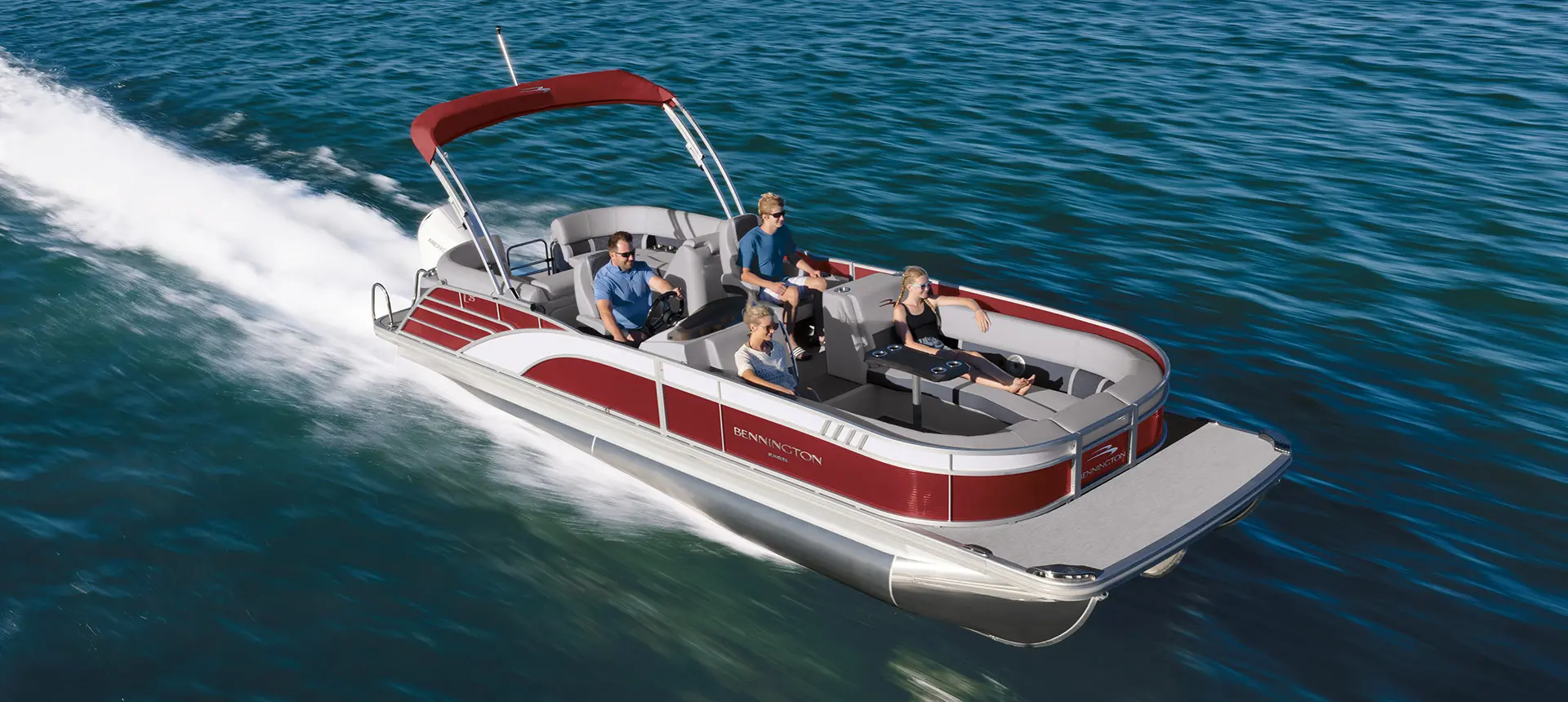 family cruising on a bennington l bowrider pontoon boat with quad bench floor plan