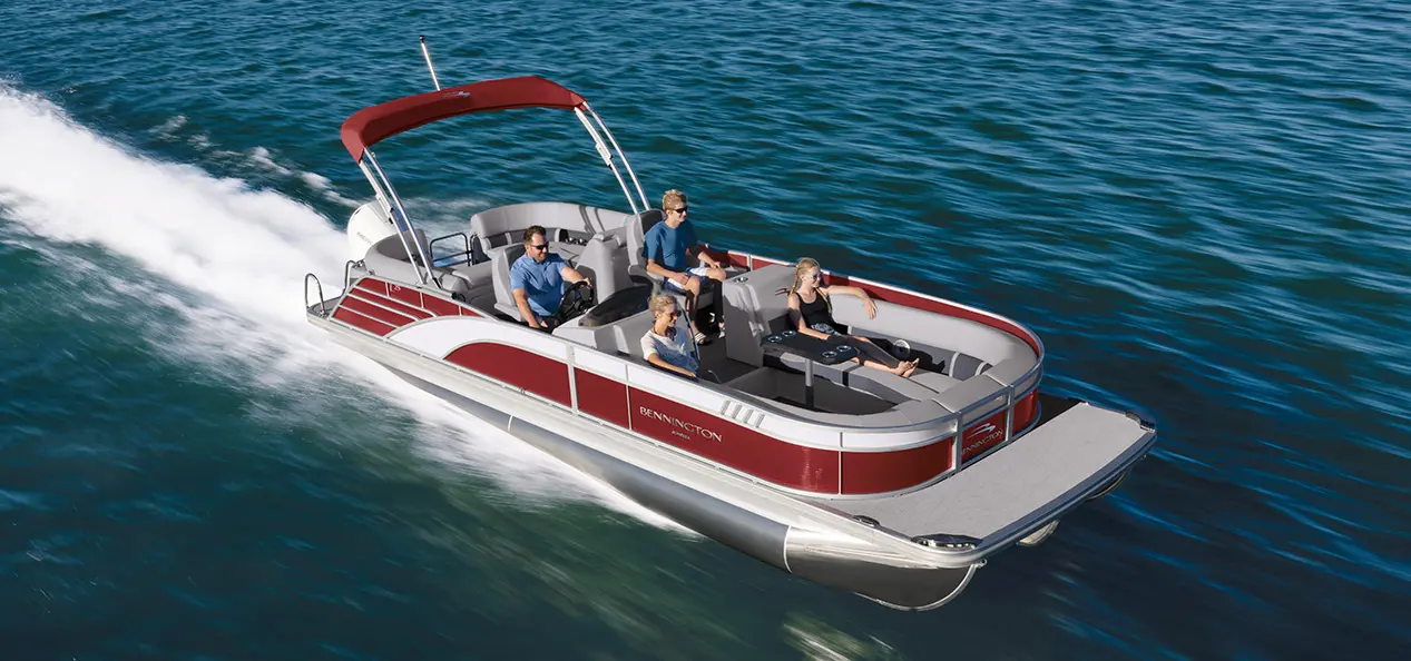 family cruising on a bennington l bowrider pontoon boat with quad bench floor plan