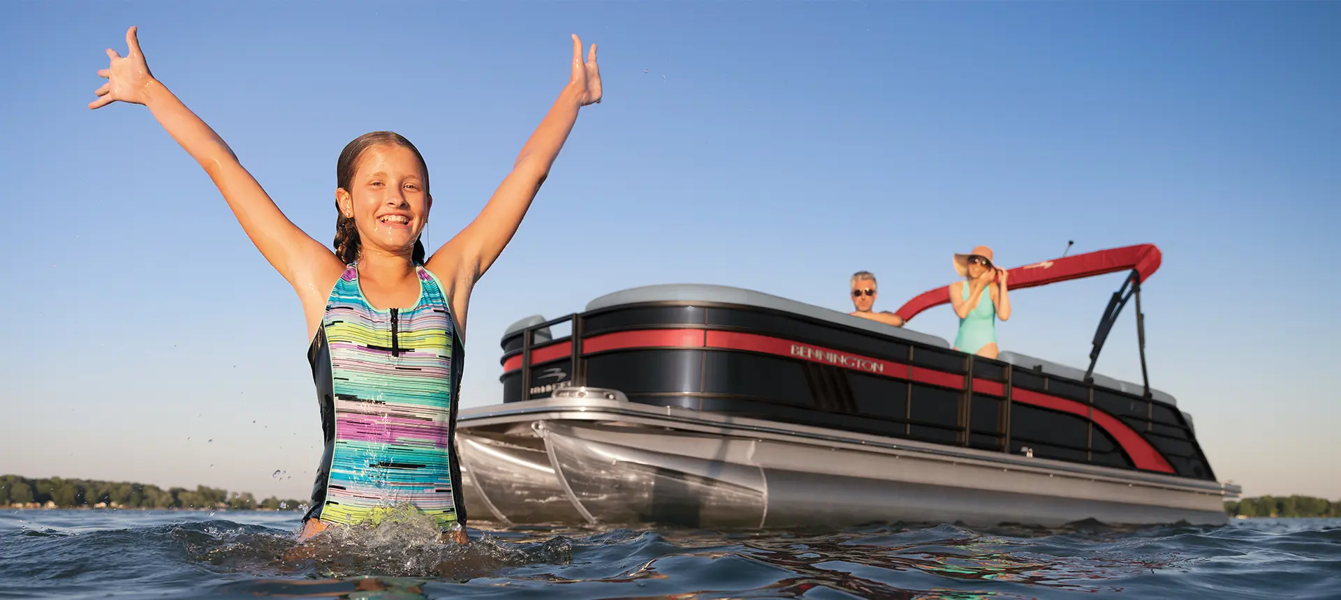 girl swimming near the bow of a bennington l pontoon boat