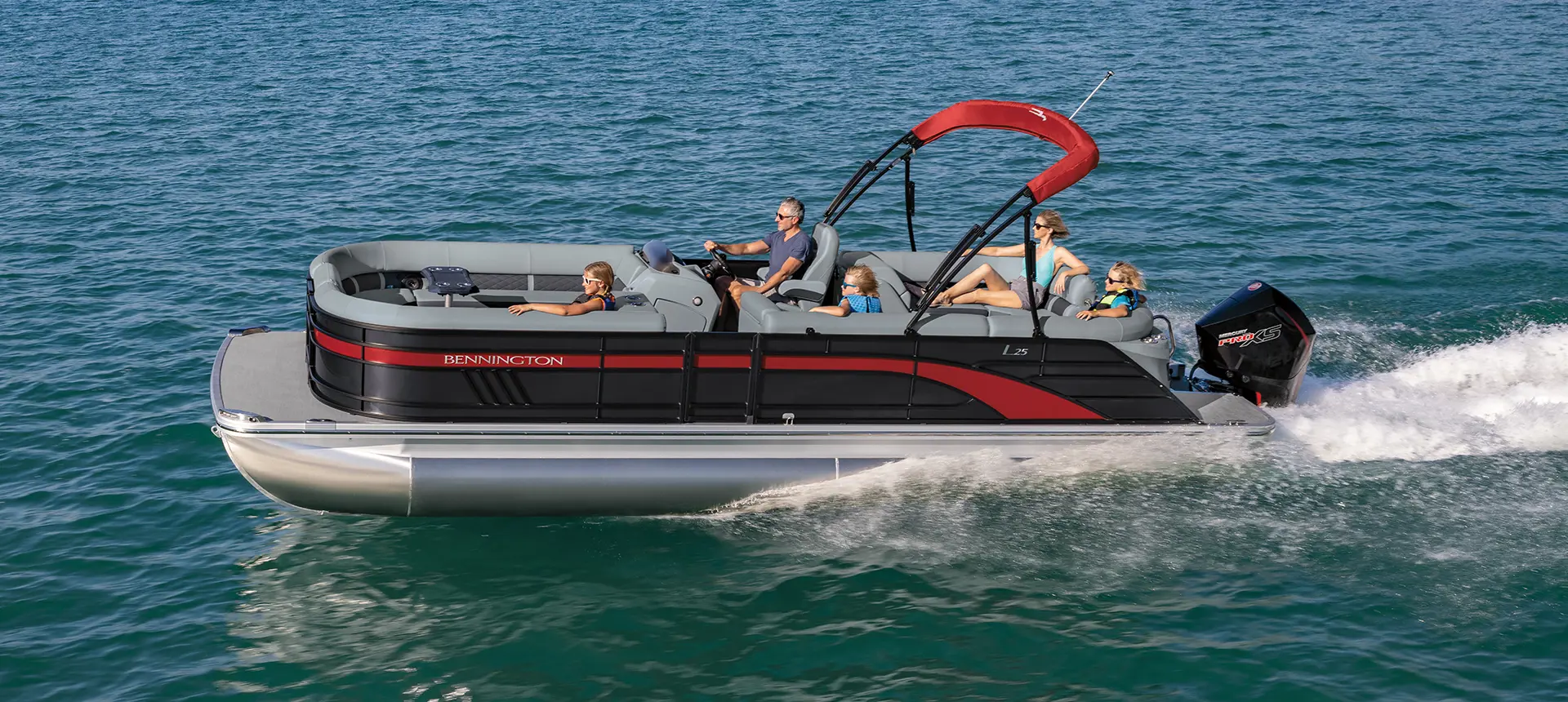 side view of a bennington l pontoon boat cruising on a lake