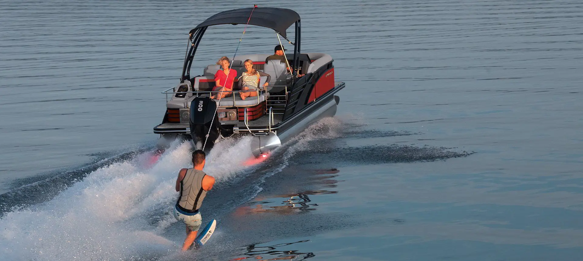 man water skiing behind a bennington lx sport pontoon boat