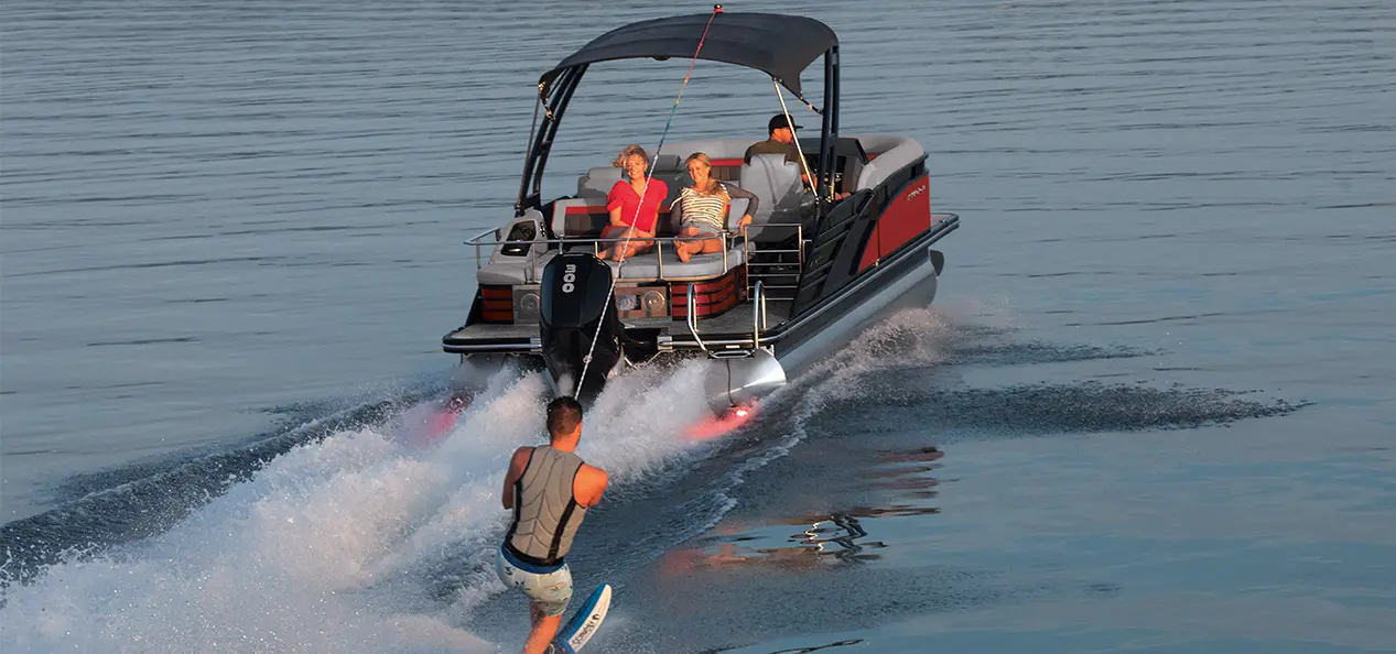 man water skiing behind a bennington lx sport pontoon boat