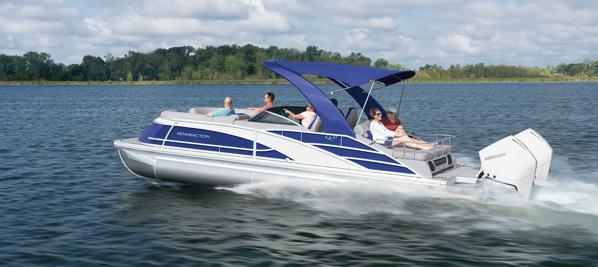 side view of a bennington q pontoon boat cruising on a lake