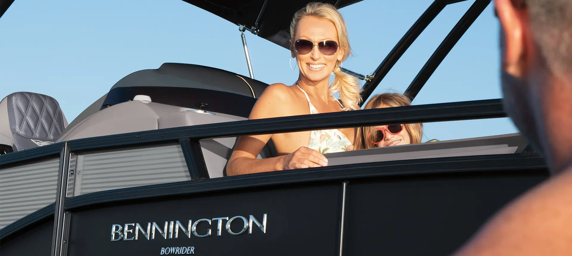 woman smiling with her daughter on a bennington r bowrider pontoon boat