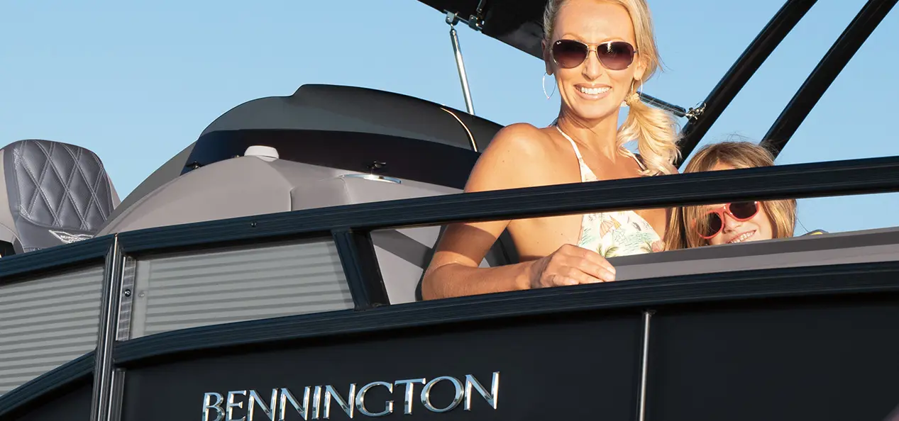 woman smiling with her daughter on a bennington r bowrider pontoon boat
