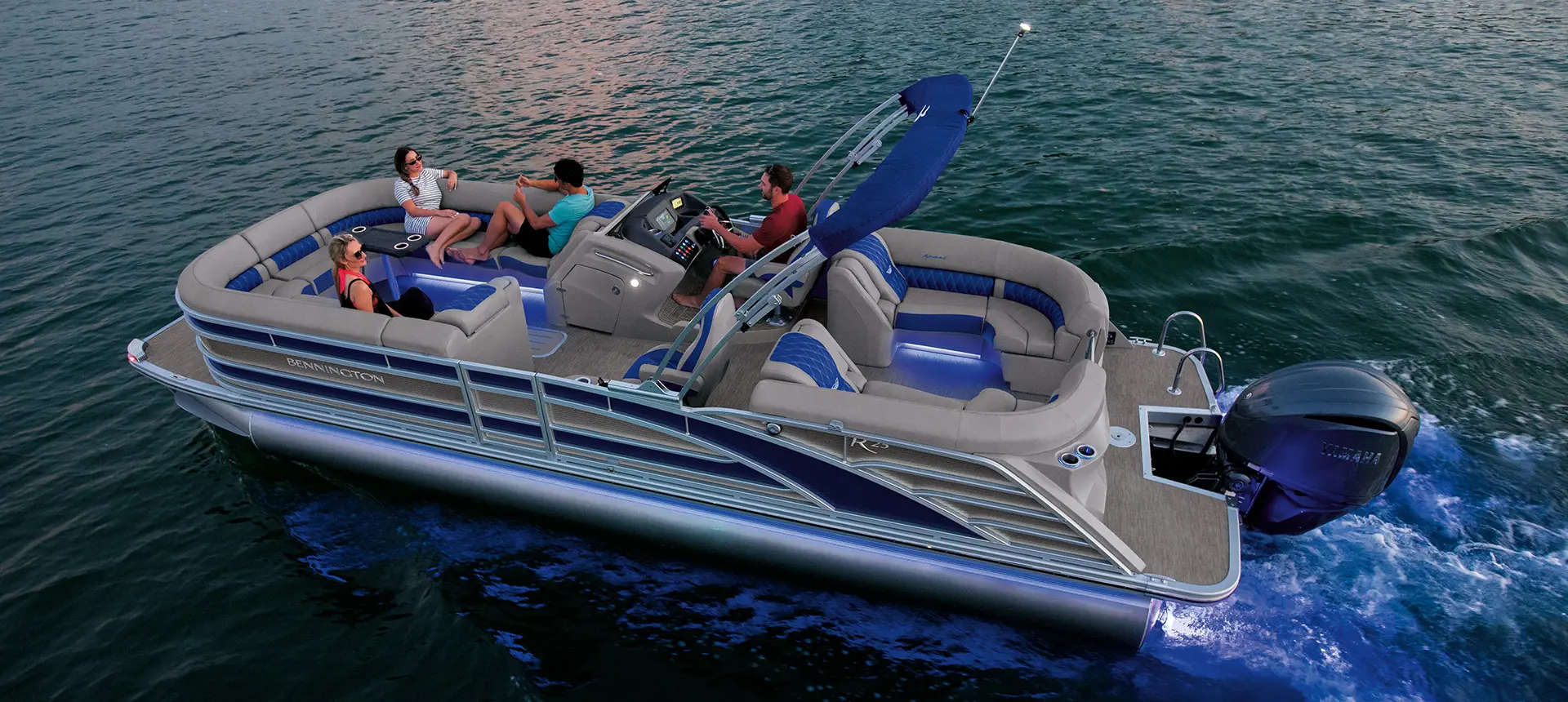 aerial view of friends sitting on a Bennington R pontoon with quad bench floor plan