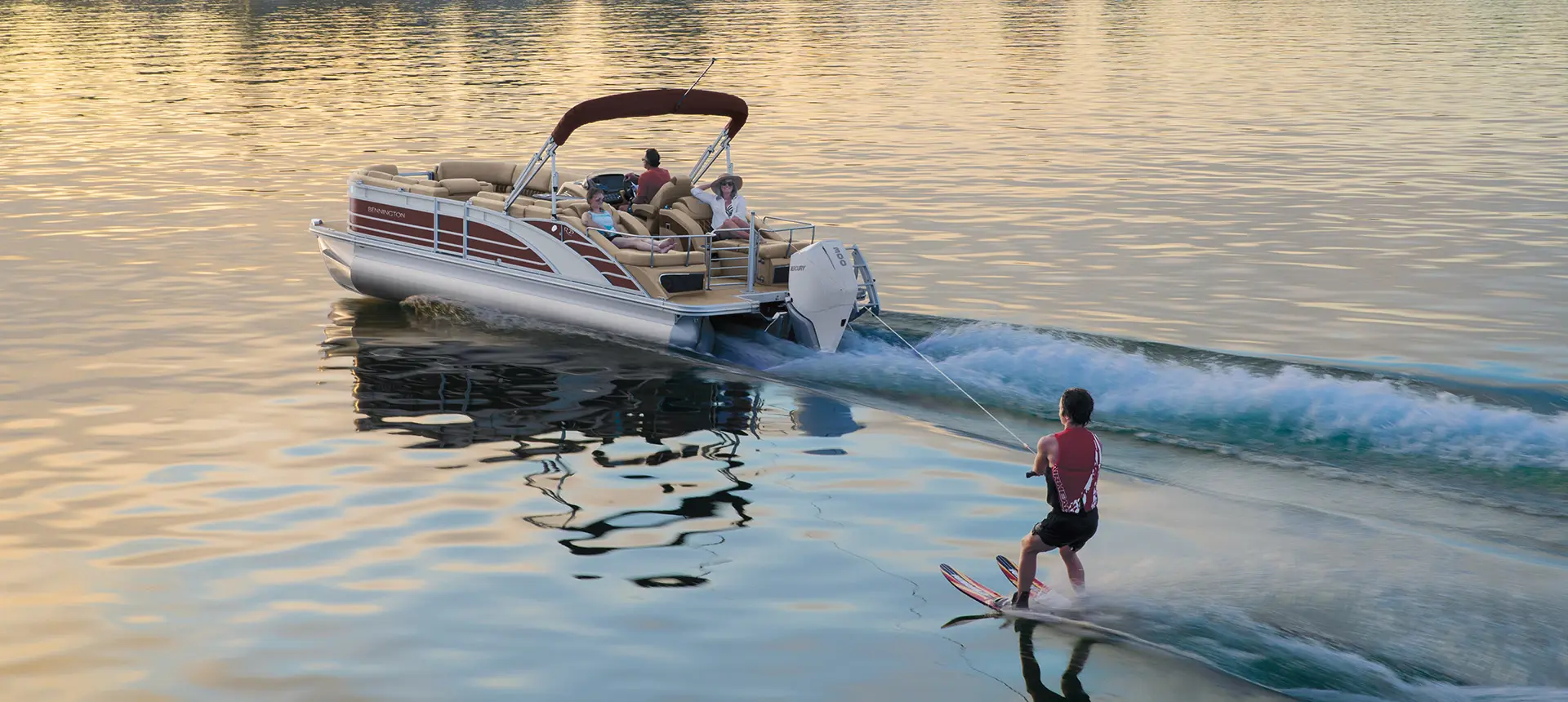 kid water skiing behind a Bennington R pontoon