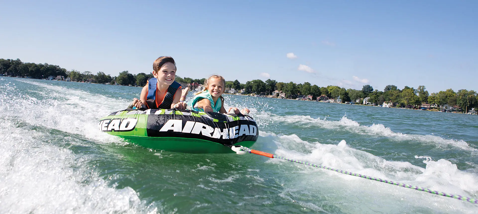 kids tubing behind a bennington rx sport pontoon boat