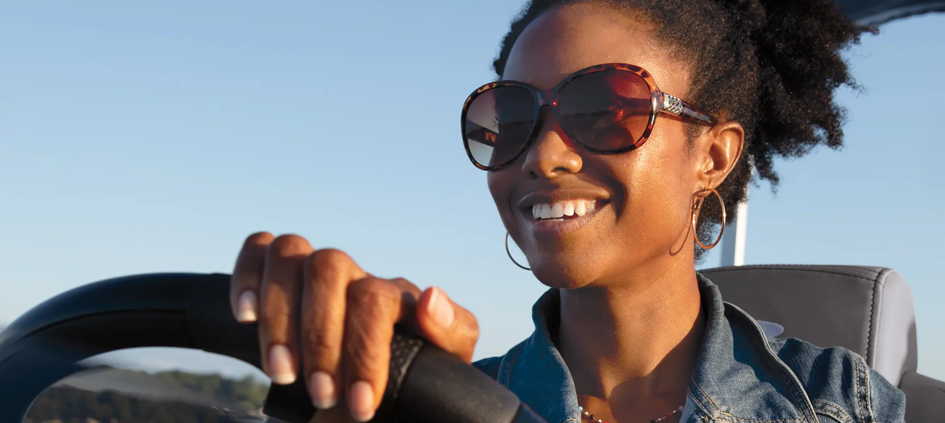 woman smiling at the helm of a Bennington S pontoon boat