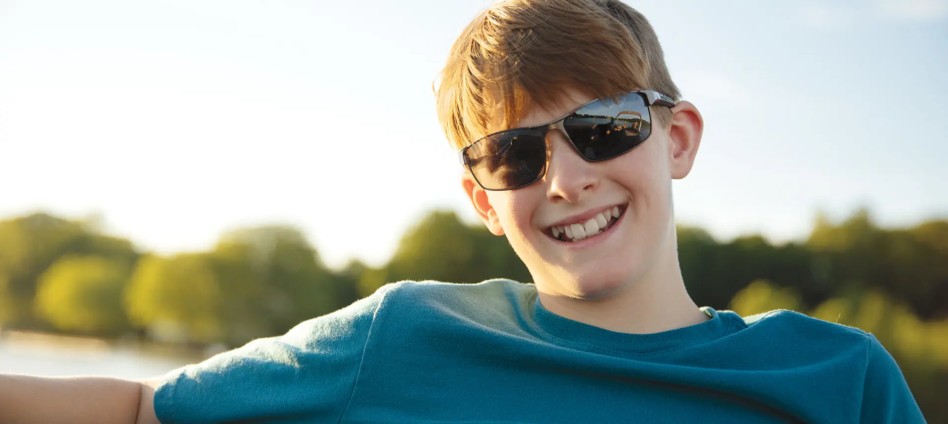 boy smiling on a bennington s pontoon boat