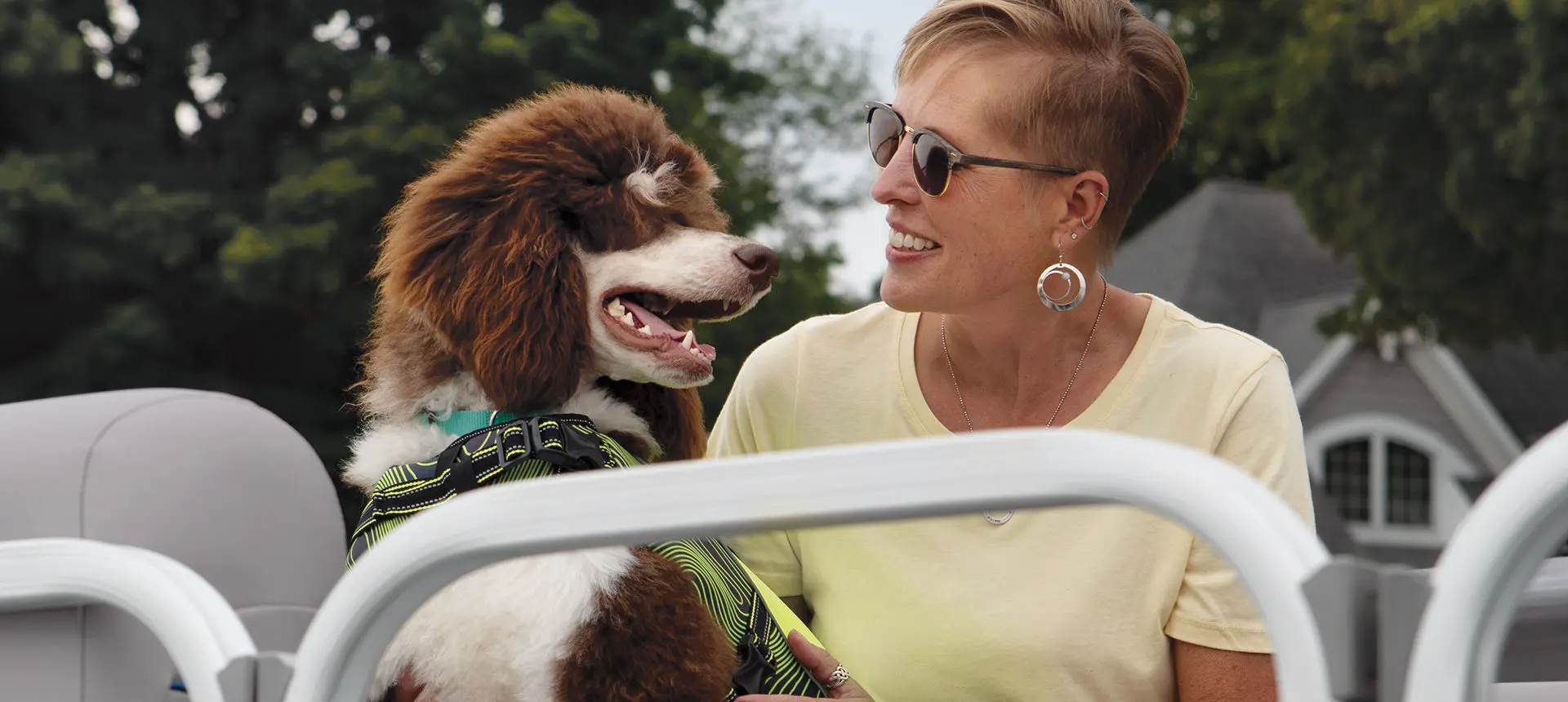woman smiling at her dog on a Bennington SV pontoon boat