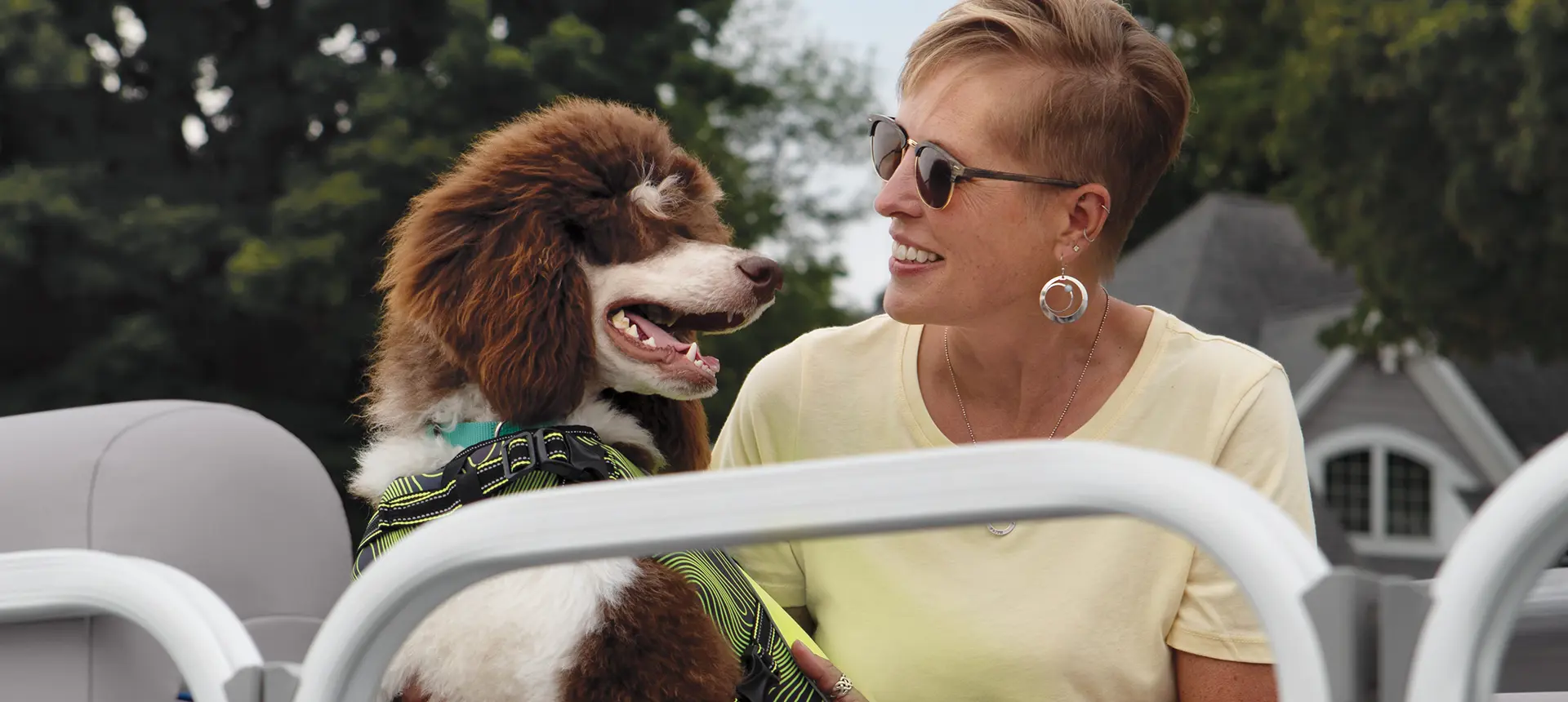 woman smiling at her dog on a Bennington SV pontoon boat
