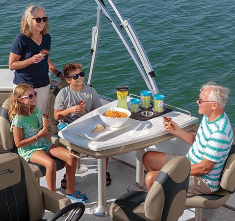 People enjoying a snack on a Bennington Luxury Entertainment pontoon boat.
