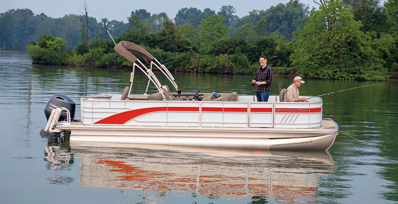 Side profile of a couple men fishing off a Bennington L Line pontoon boat with Fishing layout.
