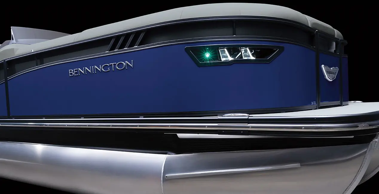 Side profile of a Bennington LX Sport pontoon boat showasing the integrated docking lights.