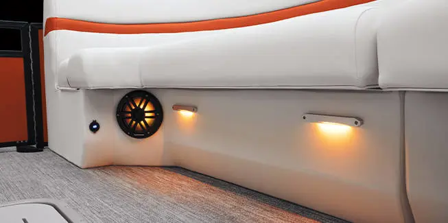 Aerial view of the bow quad bench seating and bow table on a Bennington LX Sport pontoon boat.