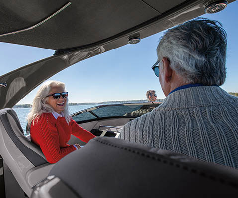 A couple enjoying the powered bimini on a Bennington Q Line pontoon boat.