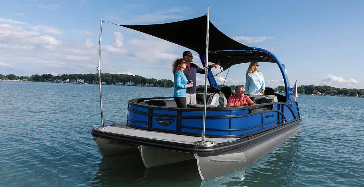 Family looking toward the lake while standing under the bimini on a Bennington R Bowrider pontoon boat.
