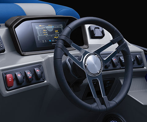 Closeup of the steering wheel, audio system, and switches on the helm of a Bennington S Line pontoon boat.