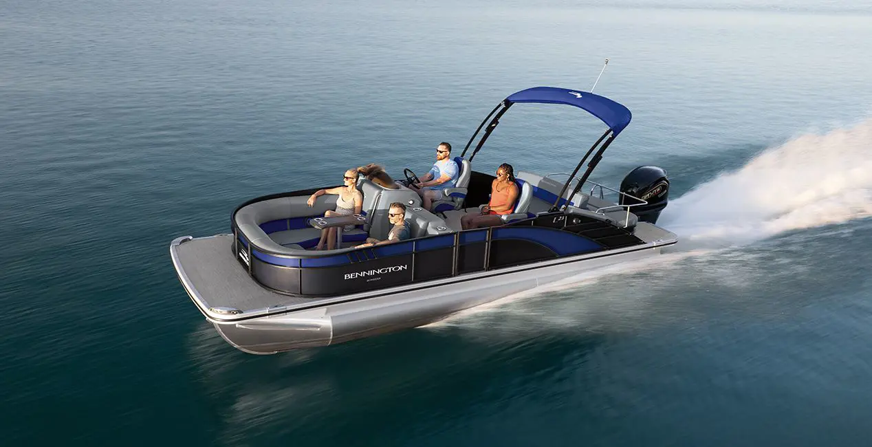 Aerial view of a Bennington Bowrider pontoon boat cruising across a lake.