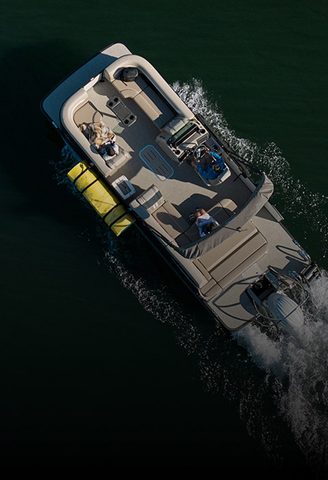 Overhead view of pontoon boat cruising on a lake with a lily pad attached to the side, using pontoon boat toolless attachment system.