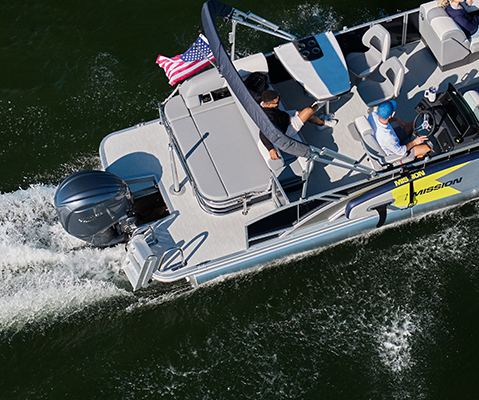 Overhead view of pontoon boat cruising on lake, with boat attachment system accessories installed. 
