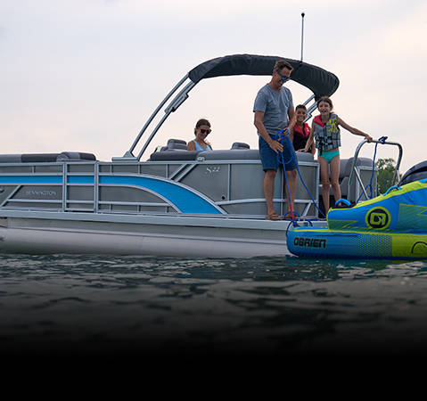 Mother and daughter lounging on a Bennington S Line pontoon boat model.
