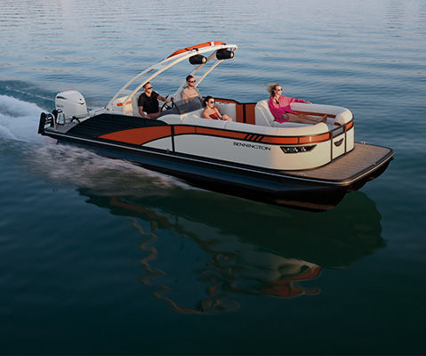 Friends speed across water in a Bennington Pontoon Boat. 