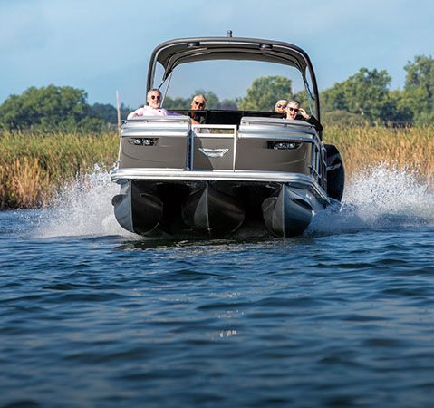 Uncompromised performance showcased on a Bennington tritoon cruising across a lake.