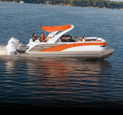 Side profile of a sporty and high-performance Bennington RX Sport pontoon on a lake.