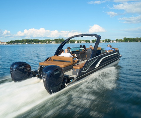 Stern focused view showcasing the twin engines on a Bennington QX line pontoon boat.