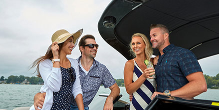 Two couples enjoying a beverage on their Bennington pontoon boat