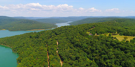 Aerial view of a tree-lined waterway in the Ozarks