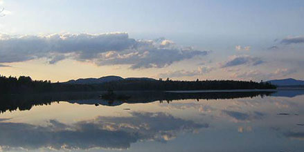 Sunset over calm lake waters
