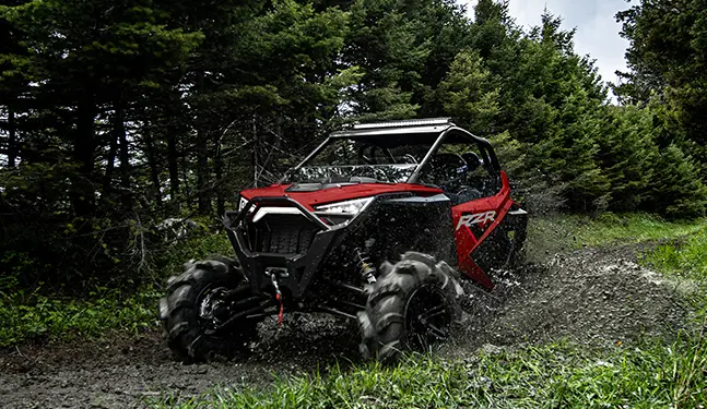A RZR-PRO-XP riding a muddy road