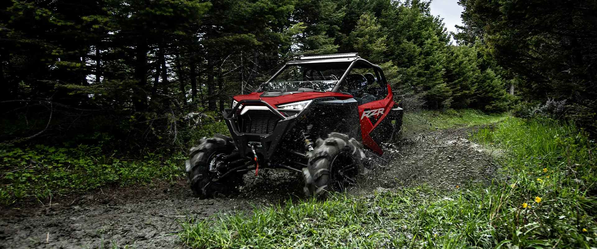 A RZR-PRO-XP riding a muddy road