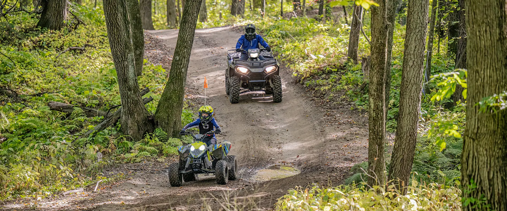 two kids riding an outlaw 110