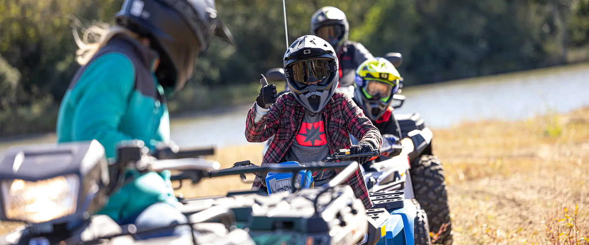 Enfant levant les pouces depuis un VTT Polaris Sportsman 110