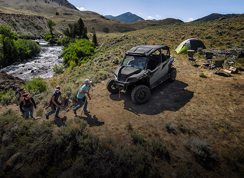 family arrives to camp setup near POLARIS GENERAL side-by-side