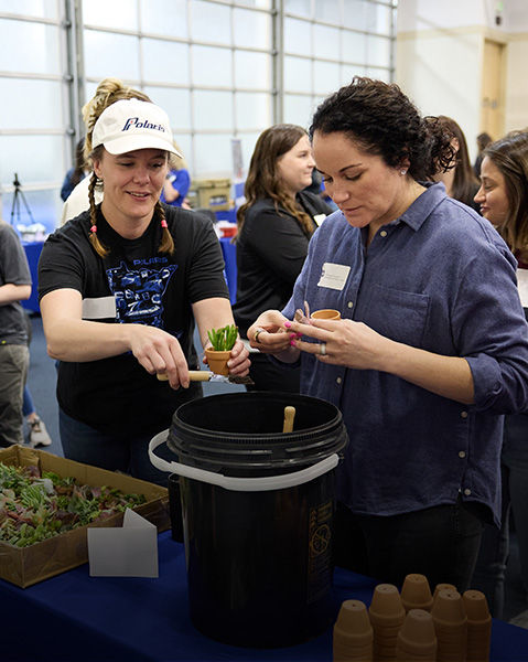 Women participating in a planting activity at a Polaris event.