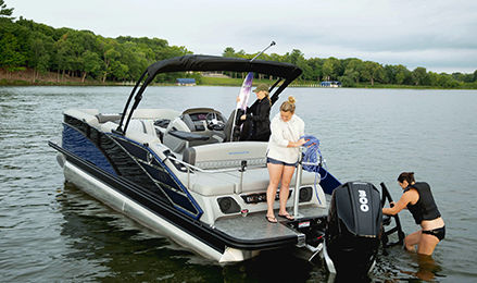 Women enjoying a Bennington pontoon boat on a lake.