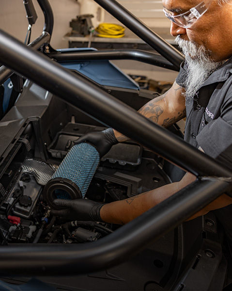 A Polaris Pro Certified Technician is installing an Air Filter to an Off-Road Vehicle.