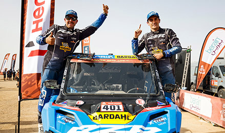 Brock Heger and Max Eddy Jr. celebrate their 2026 Dakar Rally victory behind the winning Polaris RZR Pro R Rally.
