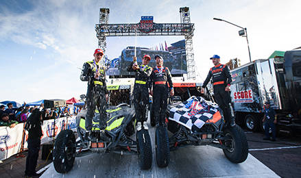 RZR Factory Racing drivers Brock Heger, Joe Terrana, and Dallas Gonzalez Jr. celebrate their 1-2-3 podium sweep at the San Felipe 250 with a champagne spray atop their race-ready vehicles.