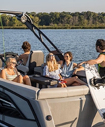 Young persons enjoying their time next to a Bennington boat