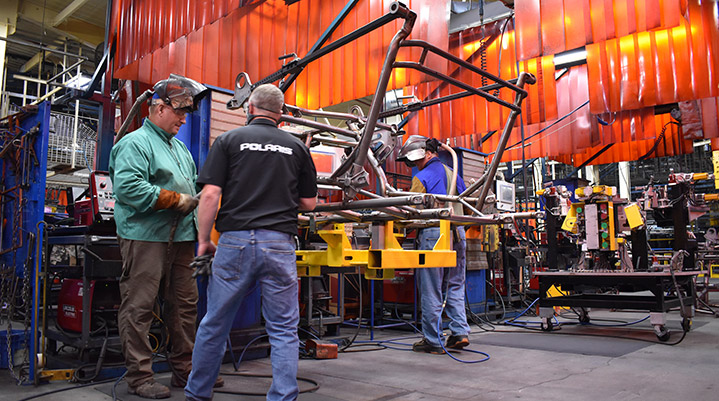 A group of Polaris' employees working on a Manufacturing installation