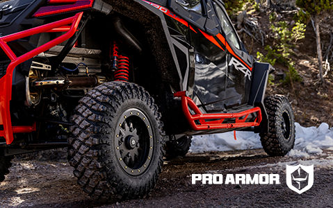 Close-up of Pro Armor accessories on a Polaris RZR, including rock sliders and wheels.